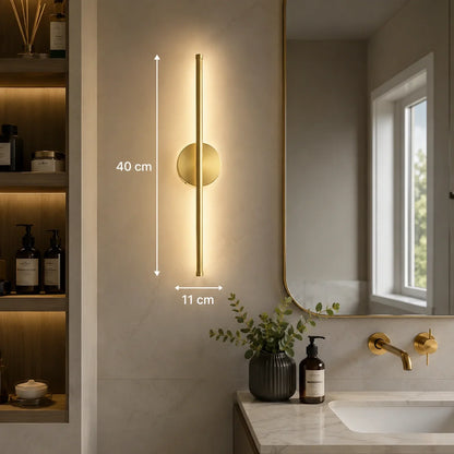 Modern 40cm gold LED wall light mounted in a bathroom, featuring a slim vertical design with warm illumination and clear dimension measurements.