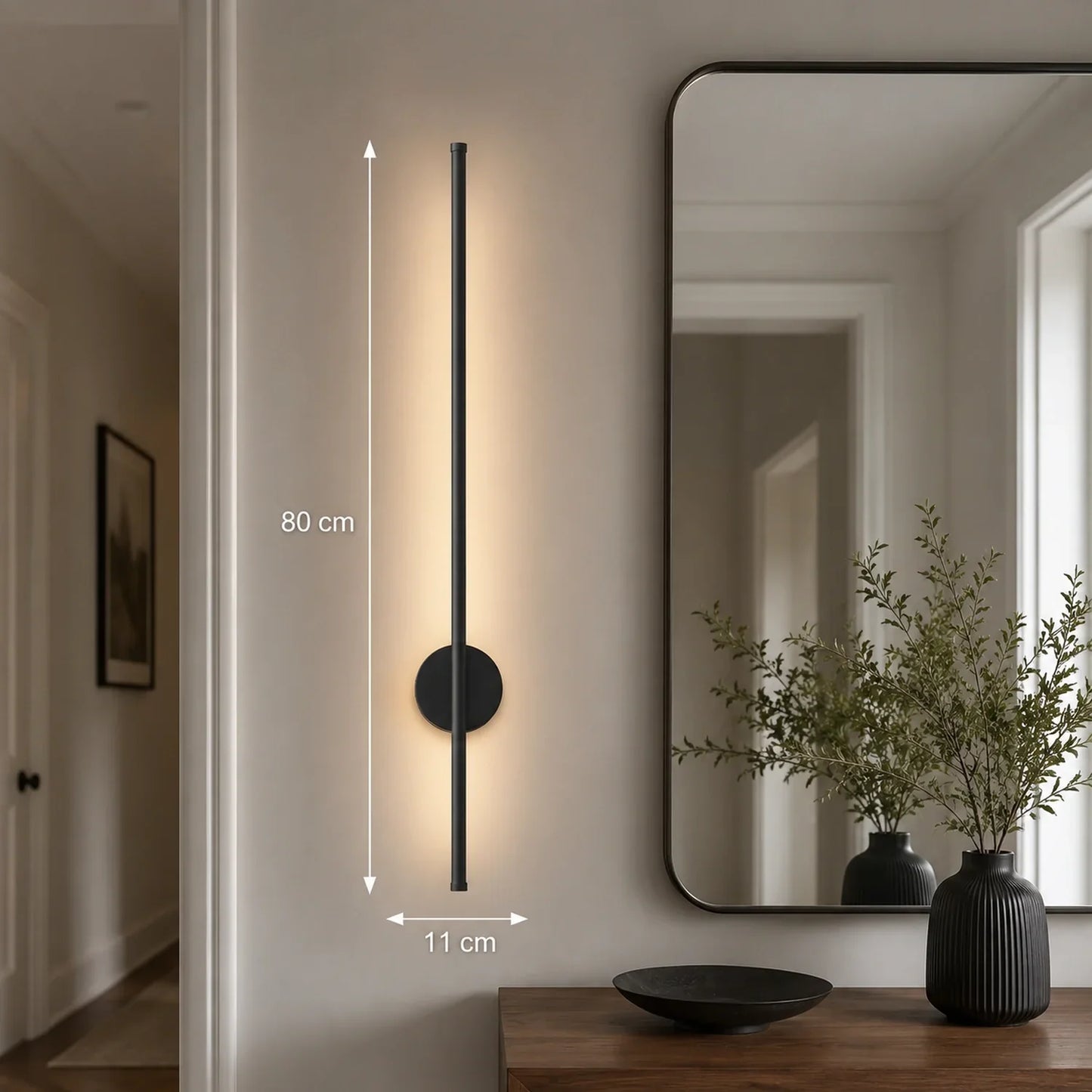 80cm black dimmable LED wall light mounted in a hallway, featuring a slim vertical design with warm illumination and clear dimension measurements.