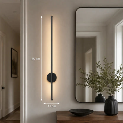 80cm black dimmable LED wall light mounted in a hallway, featuring a slim vertical design with warm illumination and clear dimension measurements.