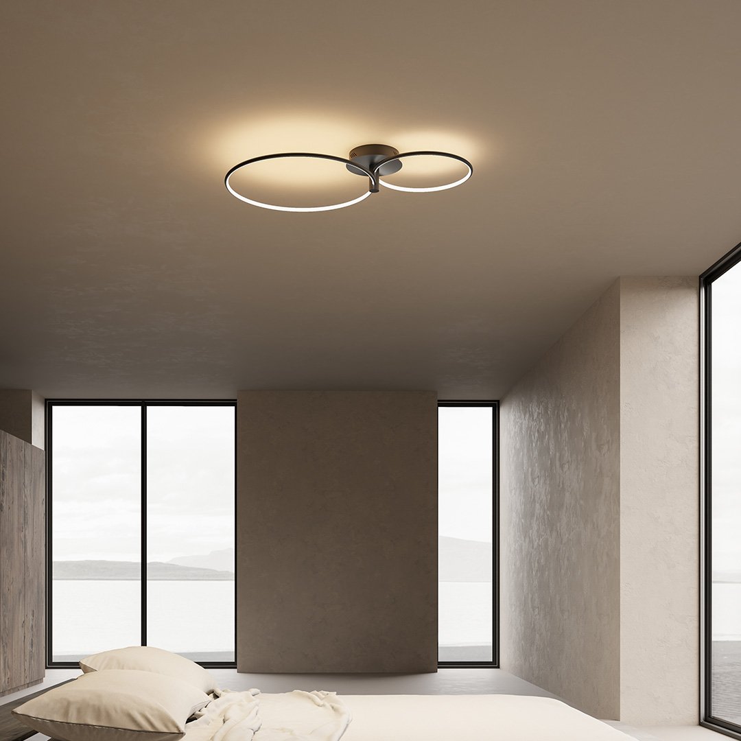 Black dimmable twin-ring LED ceiling light in a bedroom