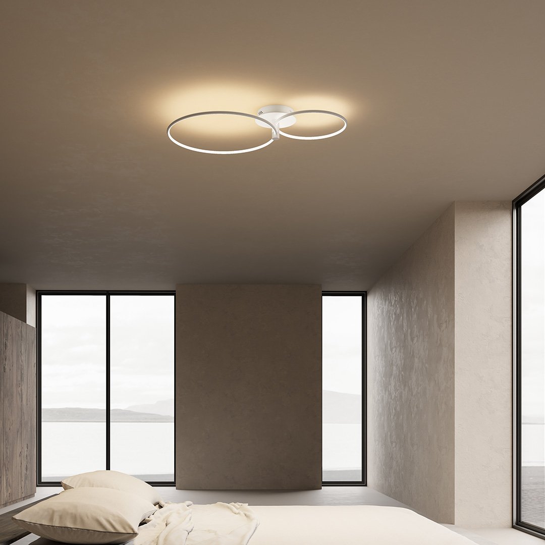 White twin-ring LED ceiling light in a bedroom