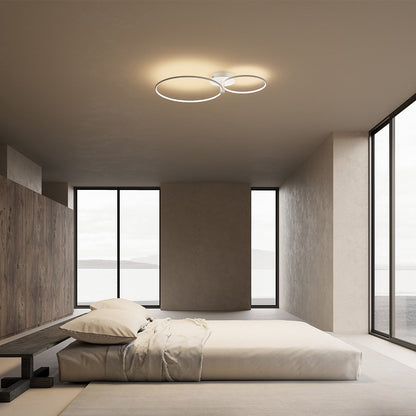 White twin-ring LED ceiling light above a bedroom