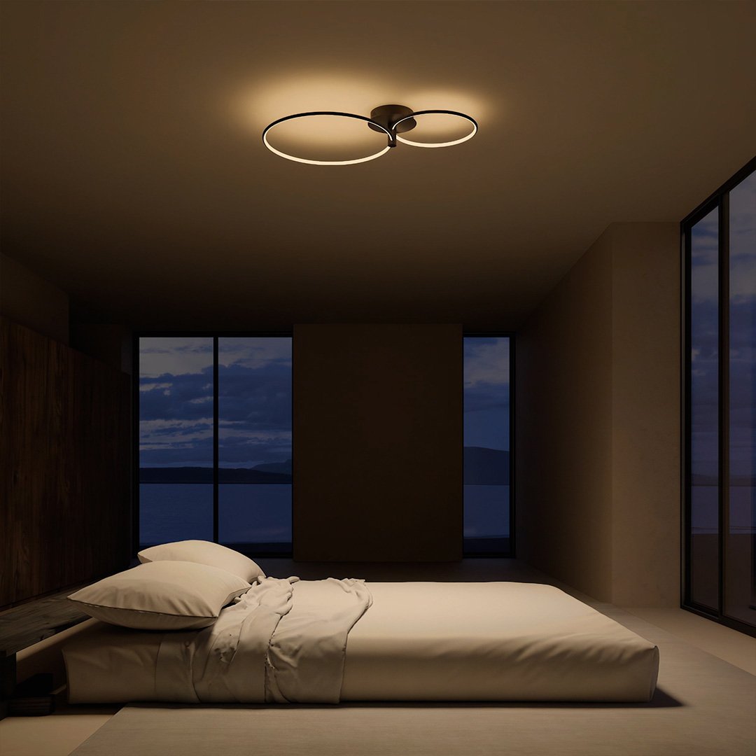 Black twin-ring LED ceiling light above a bedroom