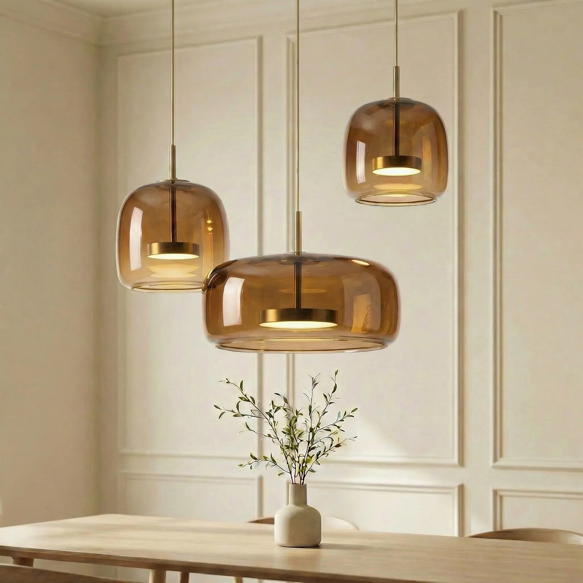 Amber glass pendant arrangement above a dining table