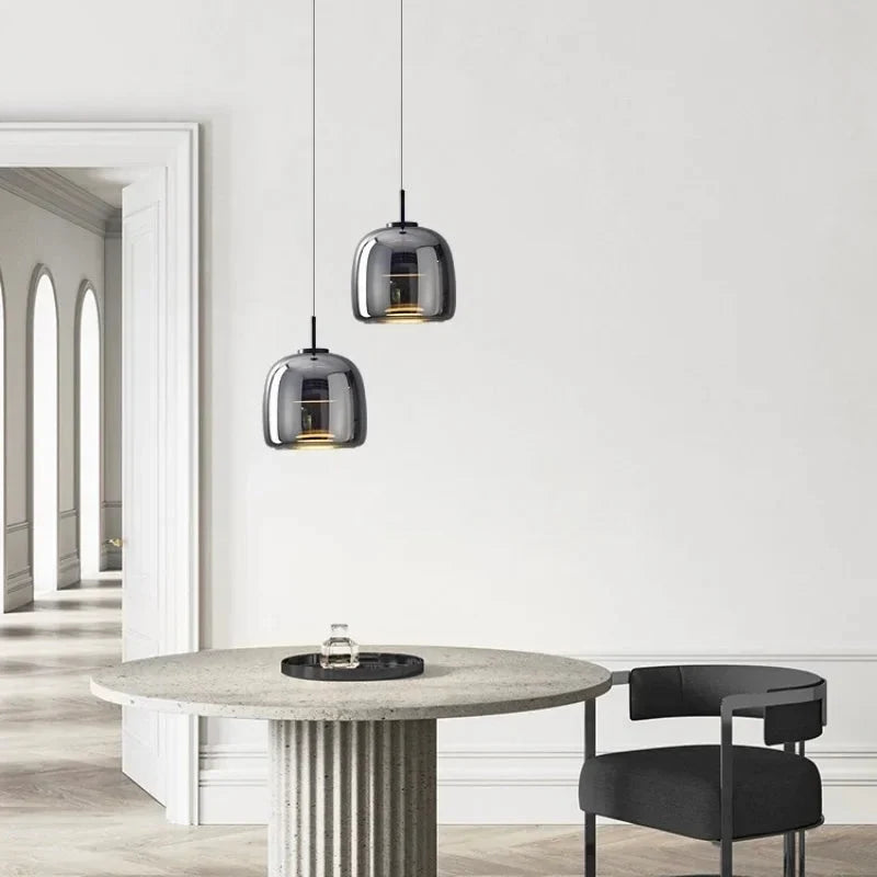 Grey dome glass pendants over a kitchen island