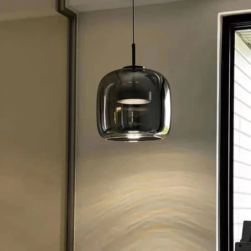 Grey glass dome pendant beside a wall