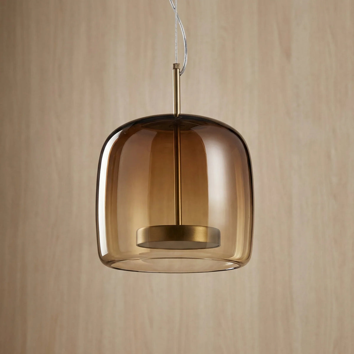 Dark amber glass pendant with a rounded dome shade