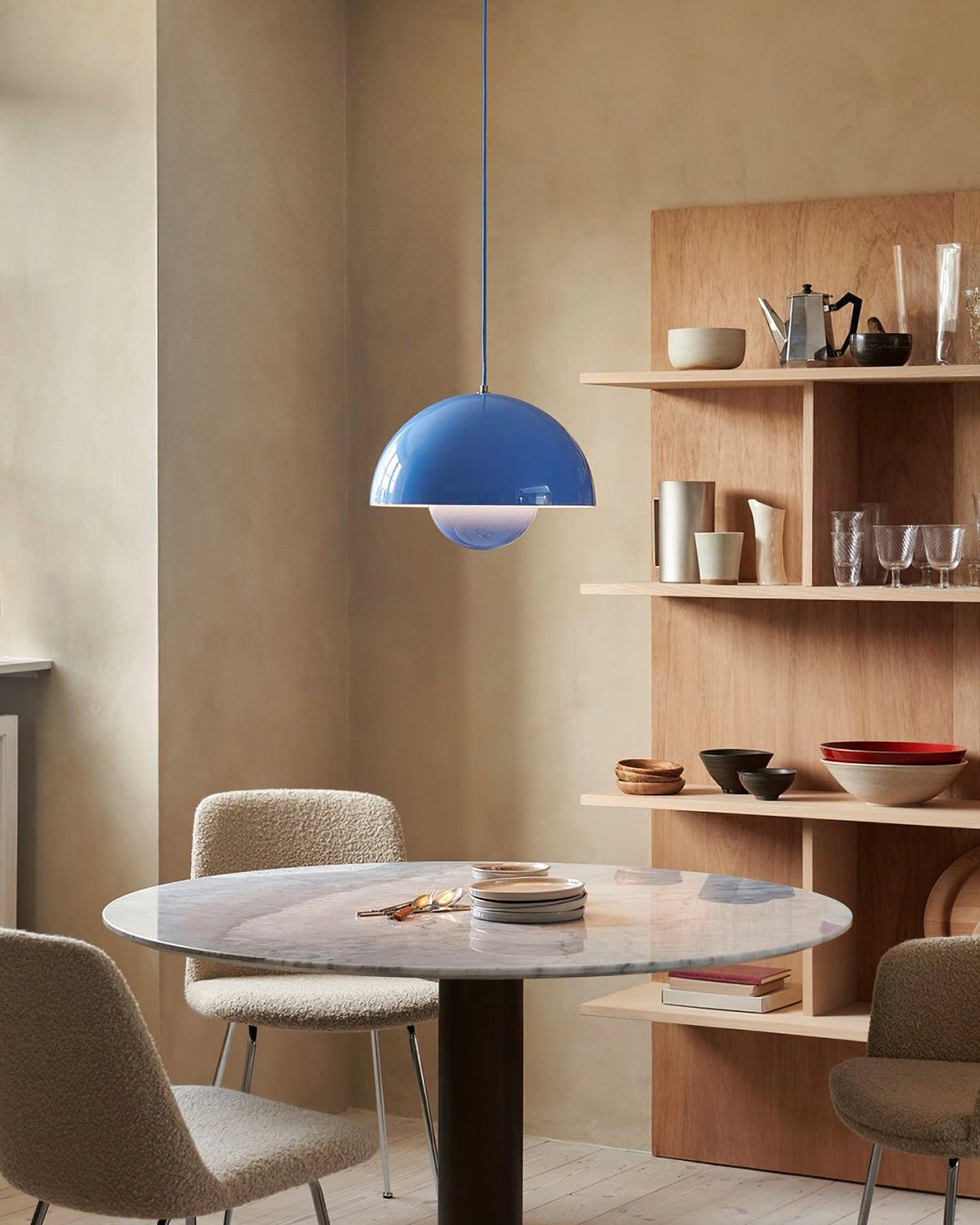 Blue dome pendant above a dining table
