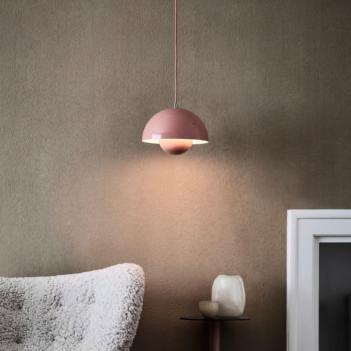 Pink dome pendant beside a chair