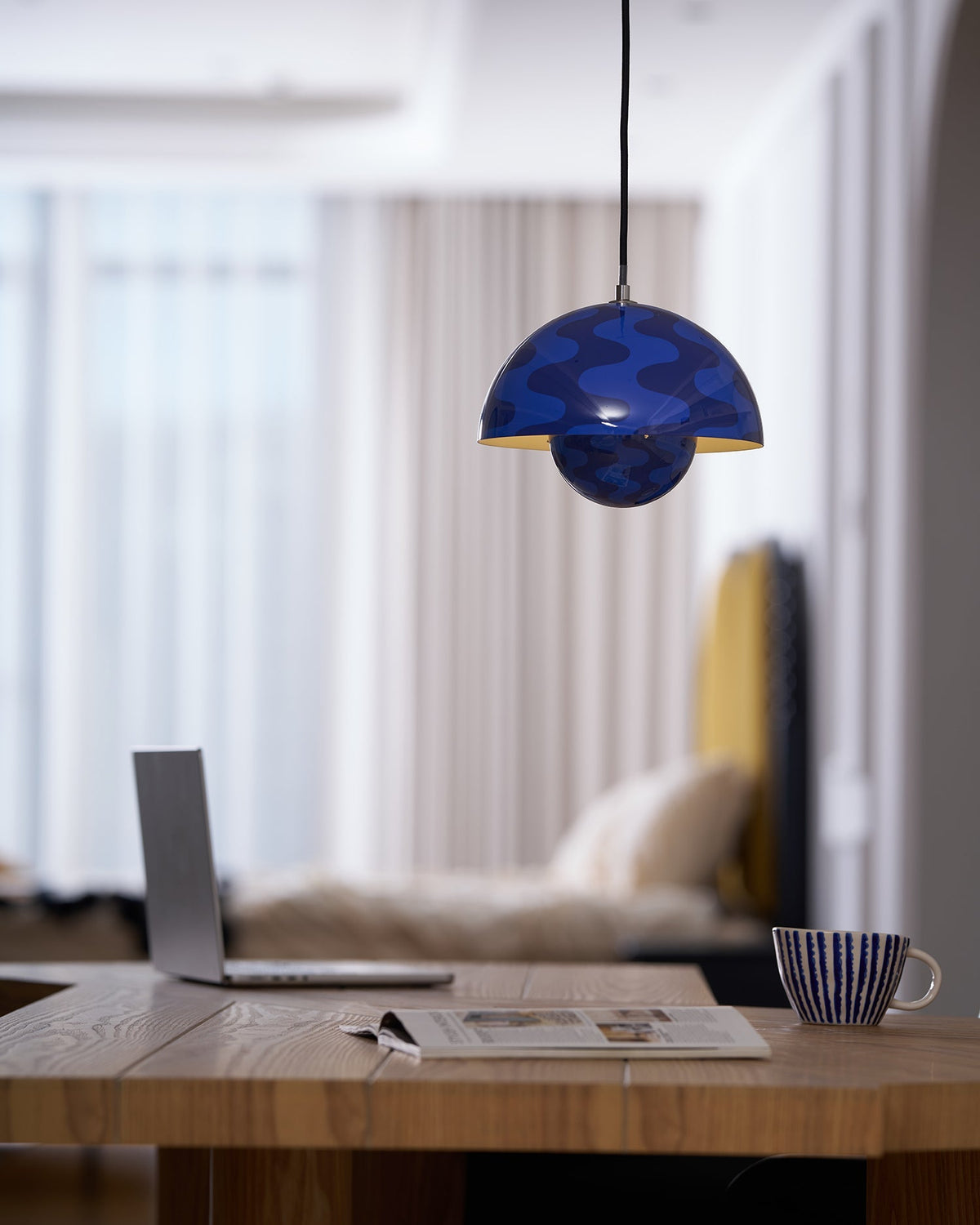 Patterned blue dome pendant above a desk