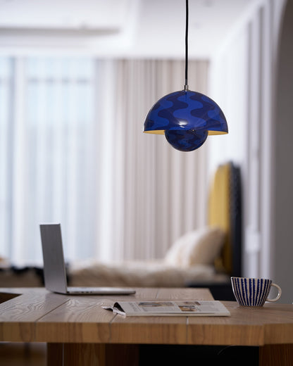 Patterned blue dome pendant above a desk