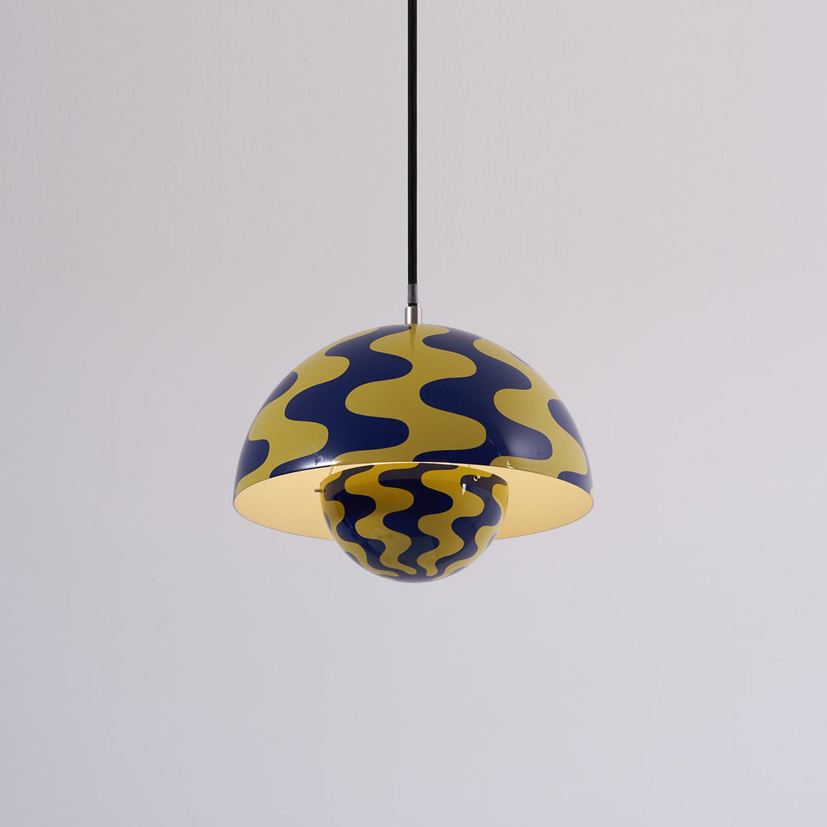 Blue and yellow patterned dome pendant with light on