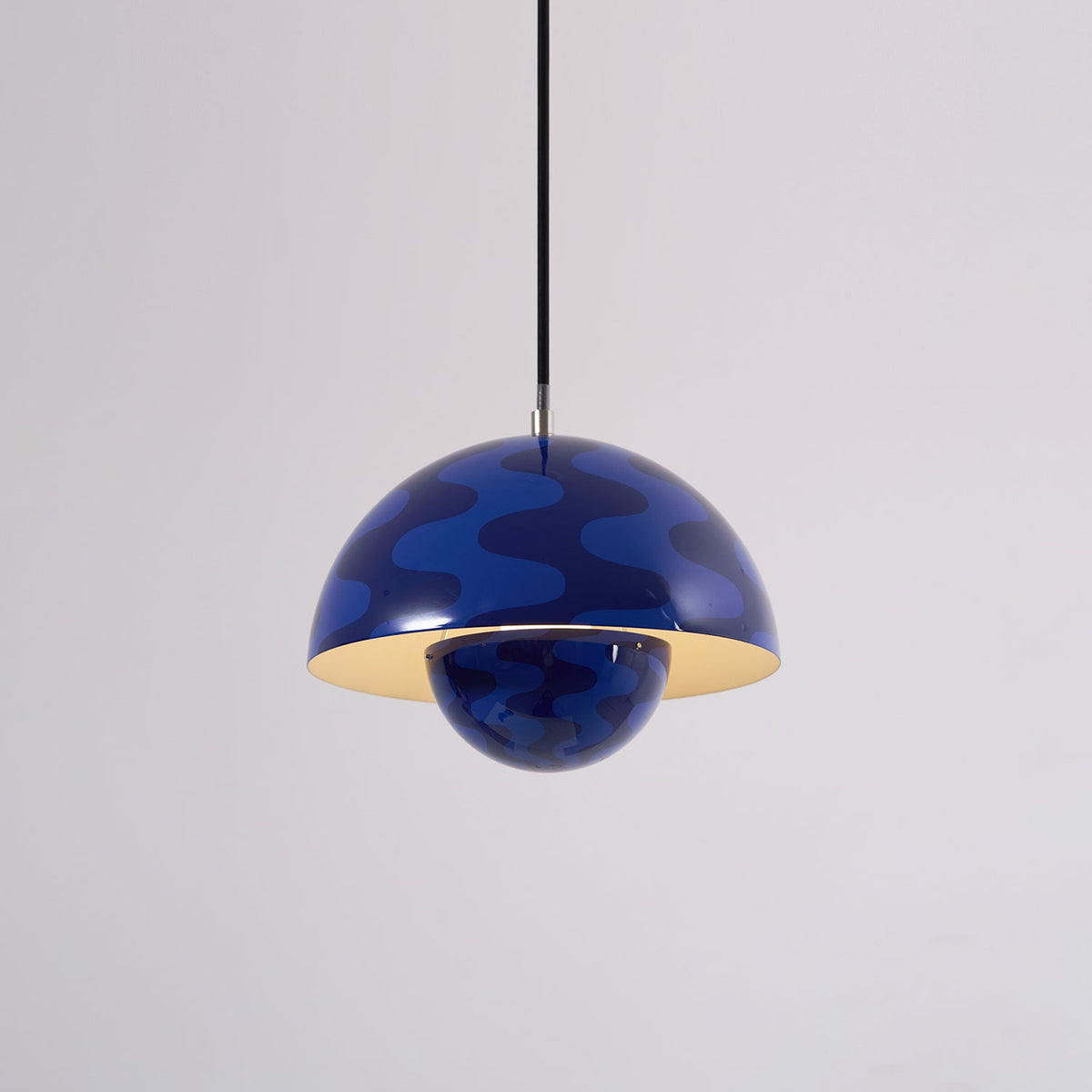 Blue patterned dome pendant with light on