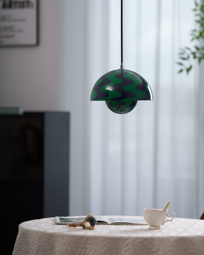Blue and green patterned dome pendant above a table