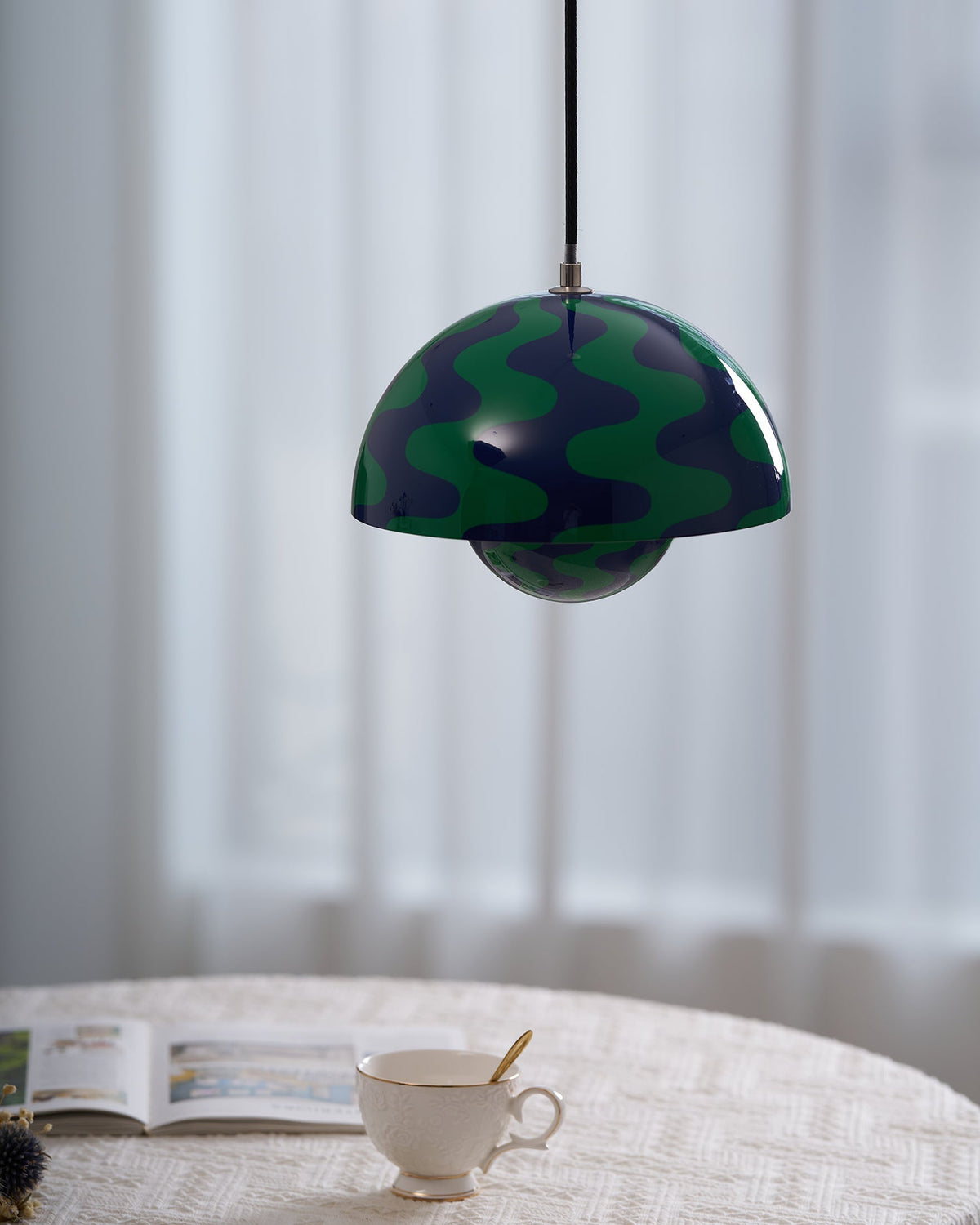 Green and blue patterned pendant with warm illumination