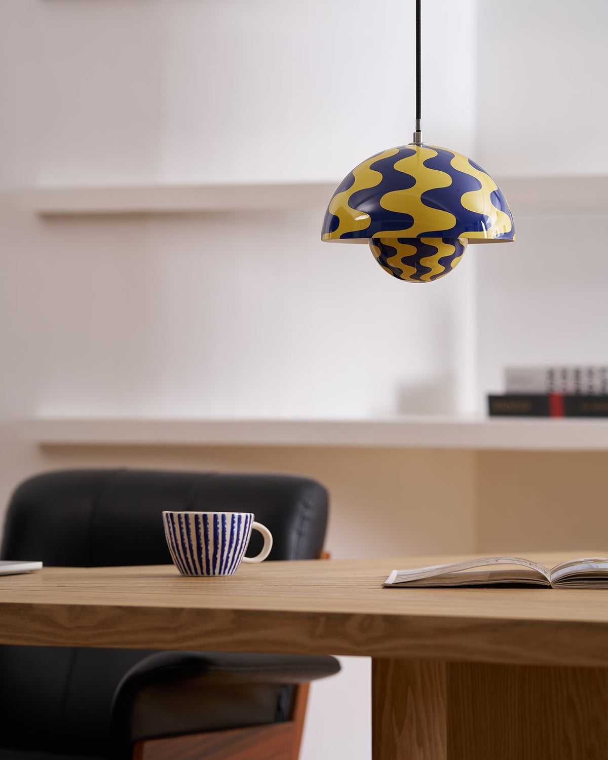 Blue and yellow patterned dome pendant above a desk