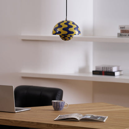 Patterned yellow and blue pendant above an open book