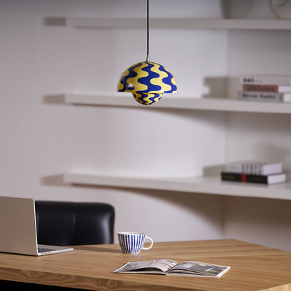 Blue and yellow dome pendant above a desk