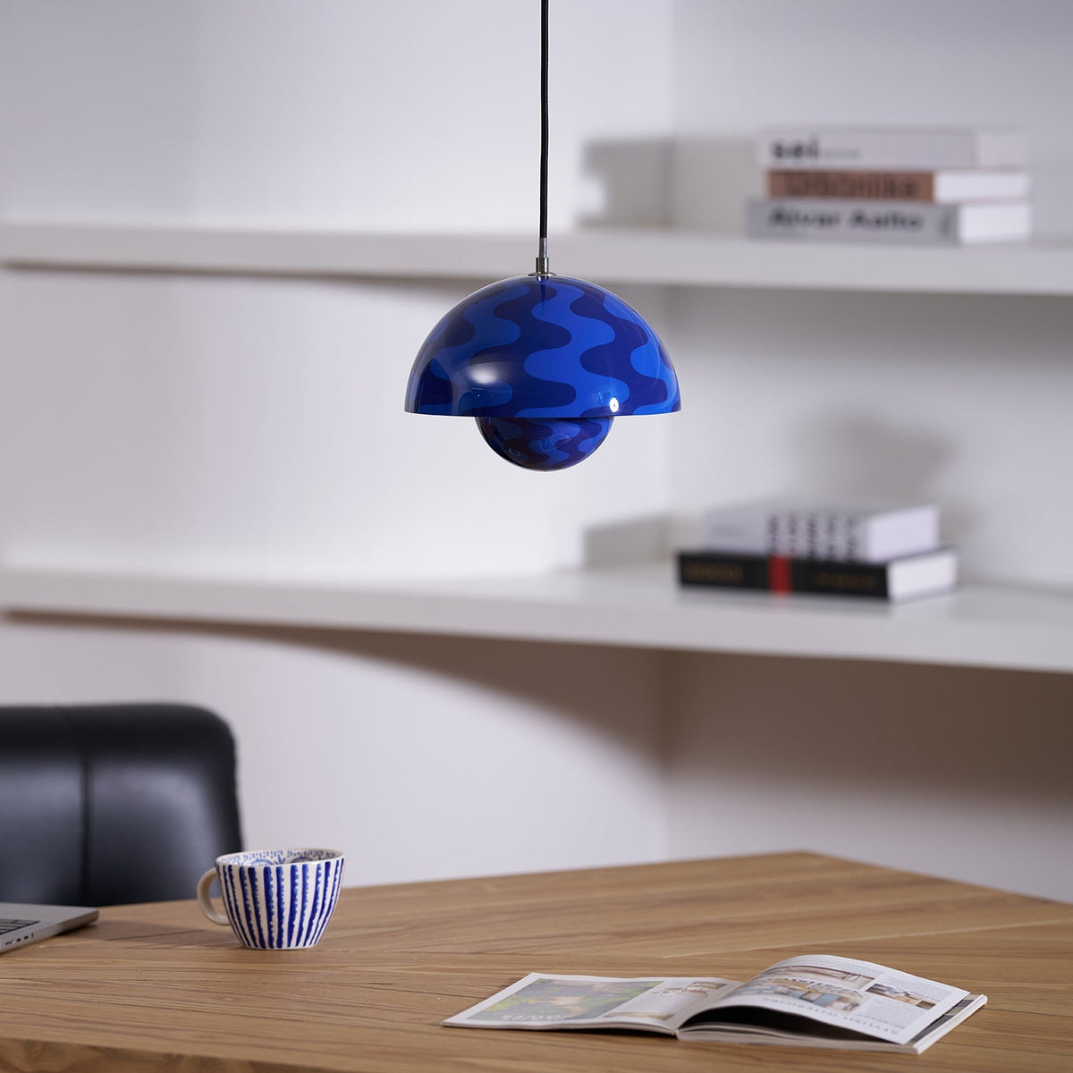 Blue patterned dome pendant above a desk