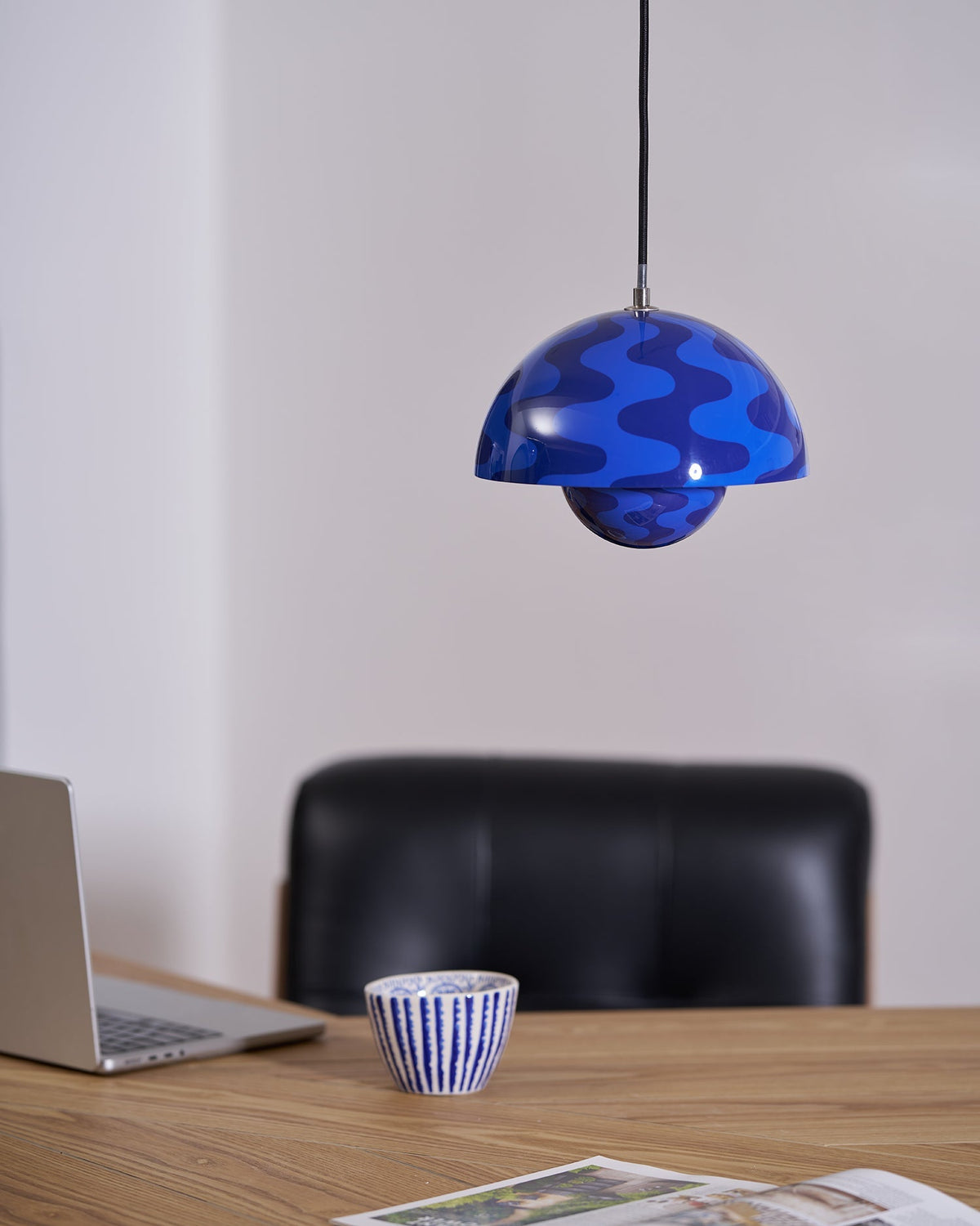 Blue patterned pendant beside shelving