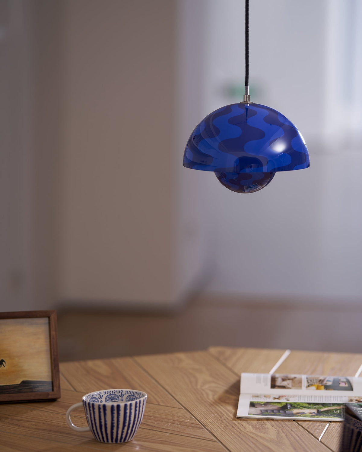 Blue patterned pendant above an open book