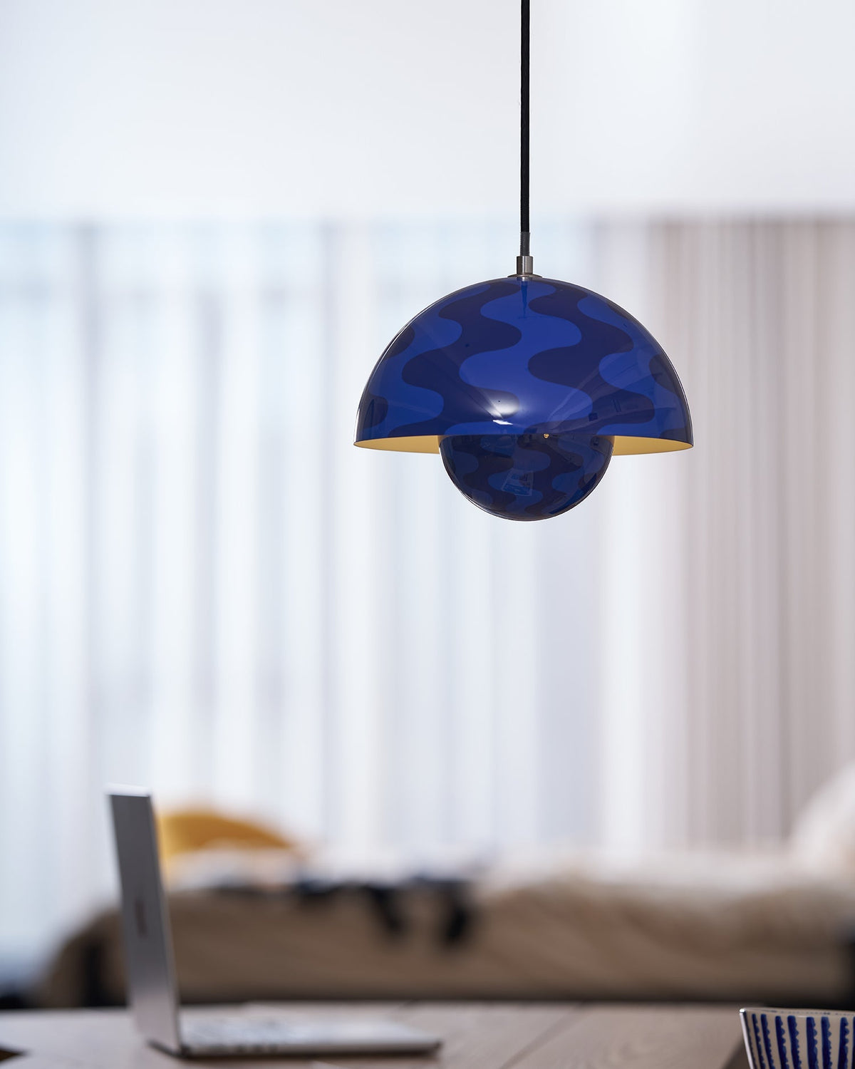 Blue patterned dome pendant beside a window