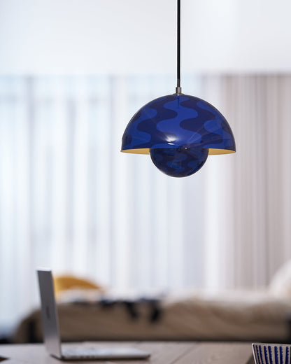 Blue patterned dome pendant beside a window