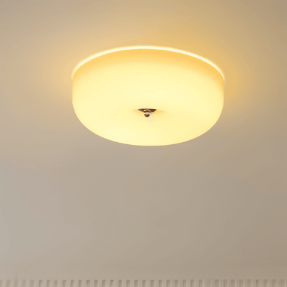 Illuminated donut glass flush ceiling light with a warm glow