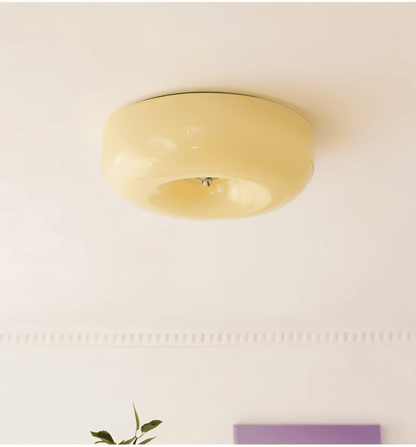 Beige donut glass ceiling light in an interior setting