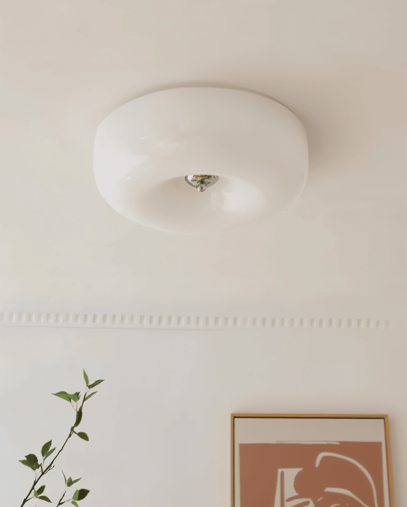 White donut glass flush ceiling light mounted on a ceiling