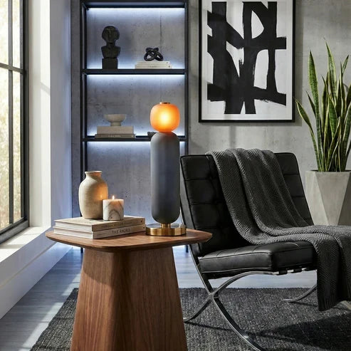 Smoky grey and orange lamp beside a chair
