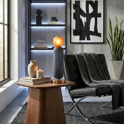 Smoky grey and orange lamp beside a chair