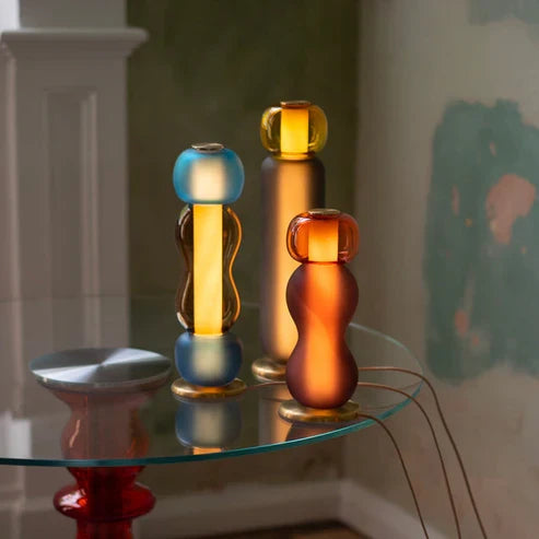Two colourful stacked glass table lamps