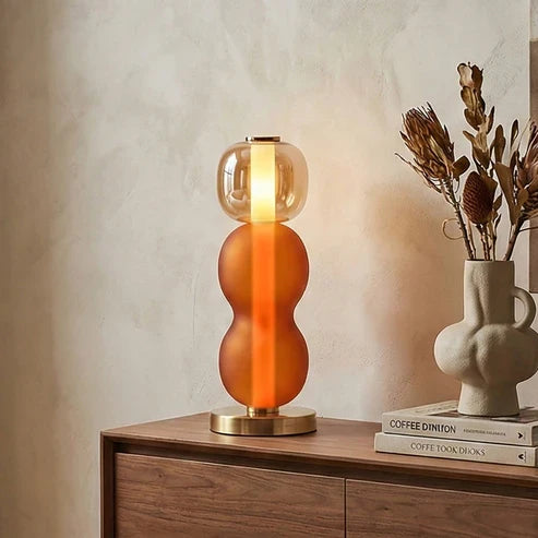 Orange Drift glass lamp on a sideboard