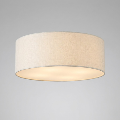 Drum flush mount ceiling light with a pale shade and bottom diffuser