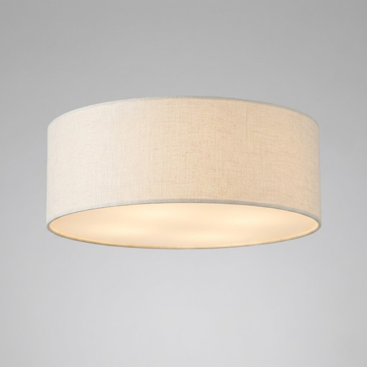Drum flush mount ceiling light with a pale shade and bottom diffuser