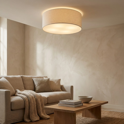Drum flush mount ceiling light providing warm light in a living room