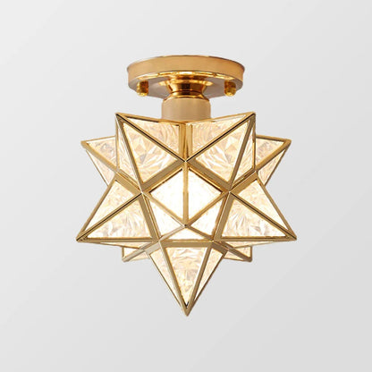 A modern five-pointed star flush mount ceiling light featuring a gold metal frame and faceted glass panels that create a warm, glowing indoor light.