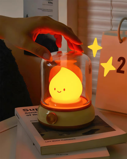 Hand touching the clear cover of a flame-shaped LED bedside lamp