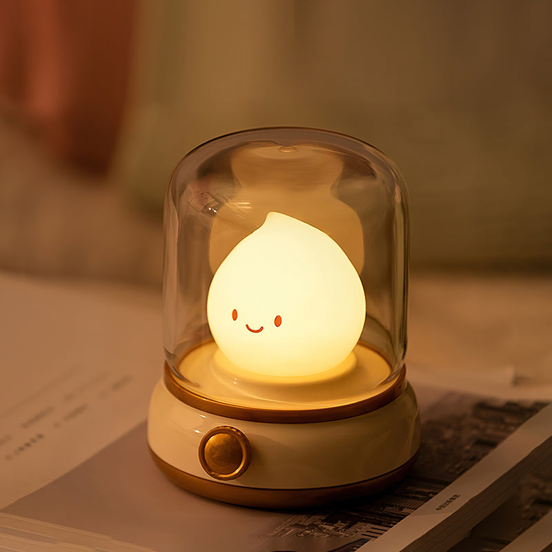 Beige lantern-style LED bedside lamp with glowing flame-shaped light 4