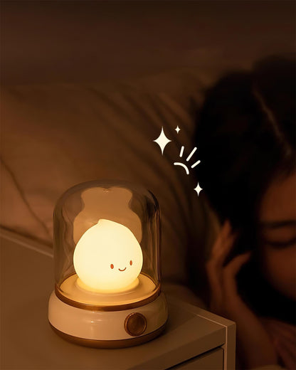 Beige lantern-style LED bedside lamp with glowing flame-shaped light 9