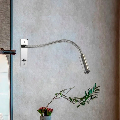 A sleek, chrome-finished flexible LED reading wall lamp mounted on a textured grey wall, perfect for modern bedside lighting and adjustable task focus.
