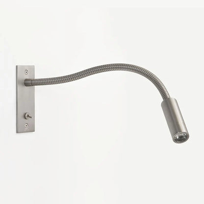 Flexible nickel LED reading wall lamp with a slim adjustable arm and integrated toggle switch, ideal for bedside lighting in a modern bedroom interior.