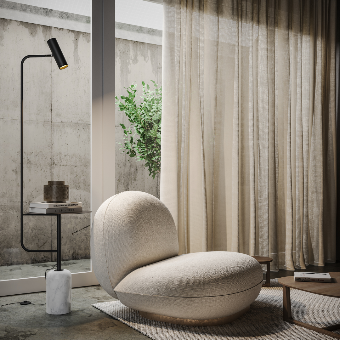 Black floor lamp with side table and marble-look base beside an armchair