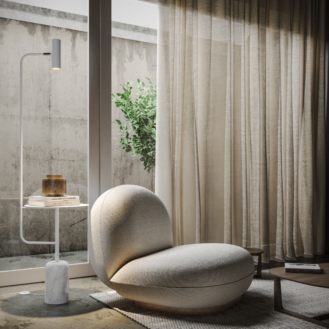 White reading floor lamp with table beside an armchair
