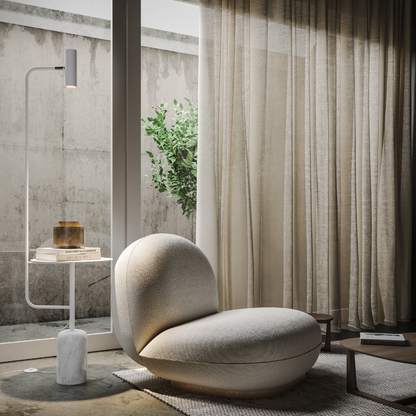 White reading floor lamp with table beside an armchair