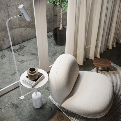 Overhead view of the white floor lamp's shelf holding books and a cup