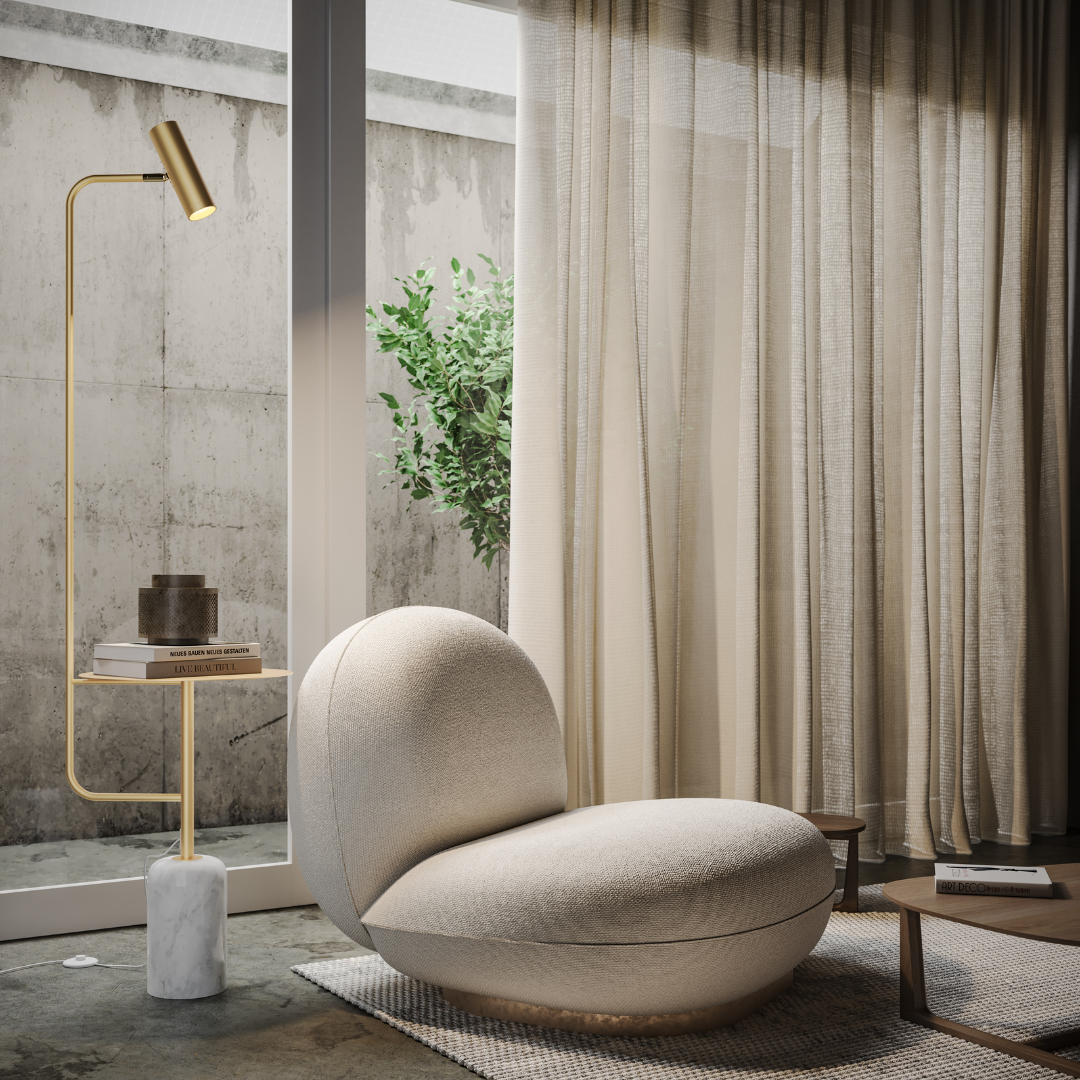 Gold floor lamp with side table beside an armchair