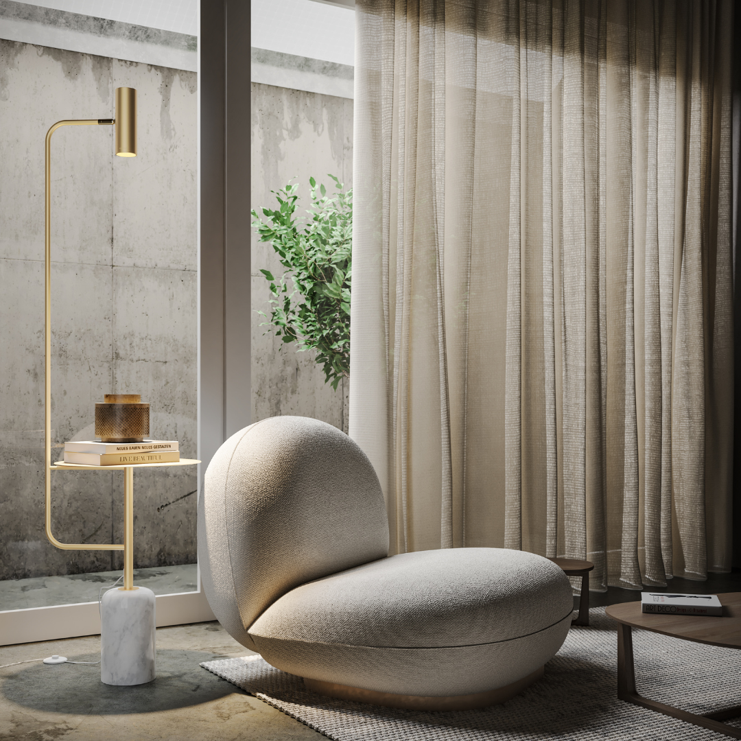 Gold reading floor lamp with table beside an armchair