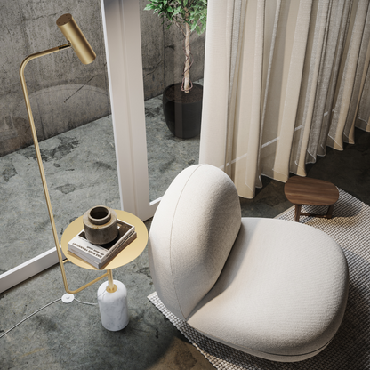 Overhead view of the gold floor lamp's shelf holding books and a cup